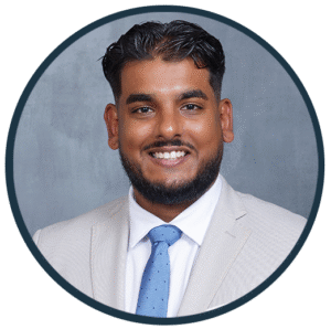 Theo Udaipaul, DMD, smiling in a professional suit, representing Westermeier Martin Dental Care's dental team.