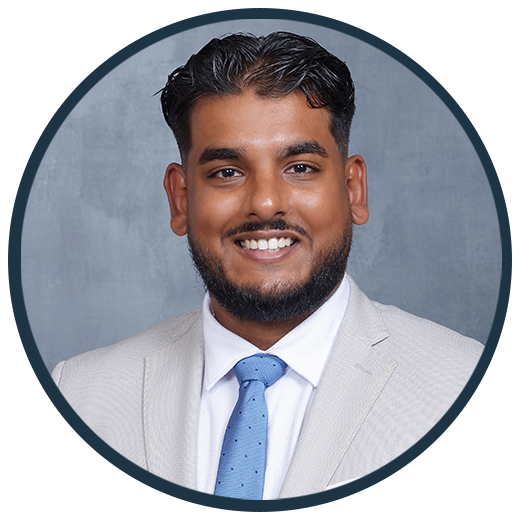 Theo Udaipaul, DMD, smiling in professional attire, representing Westermeier Martin Dental Care team.